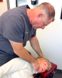 Dr. Packer adjustment v2 (4x5) Dr. David Packer performing a NUCCA chiropractic adjustment to treat headaches.