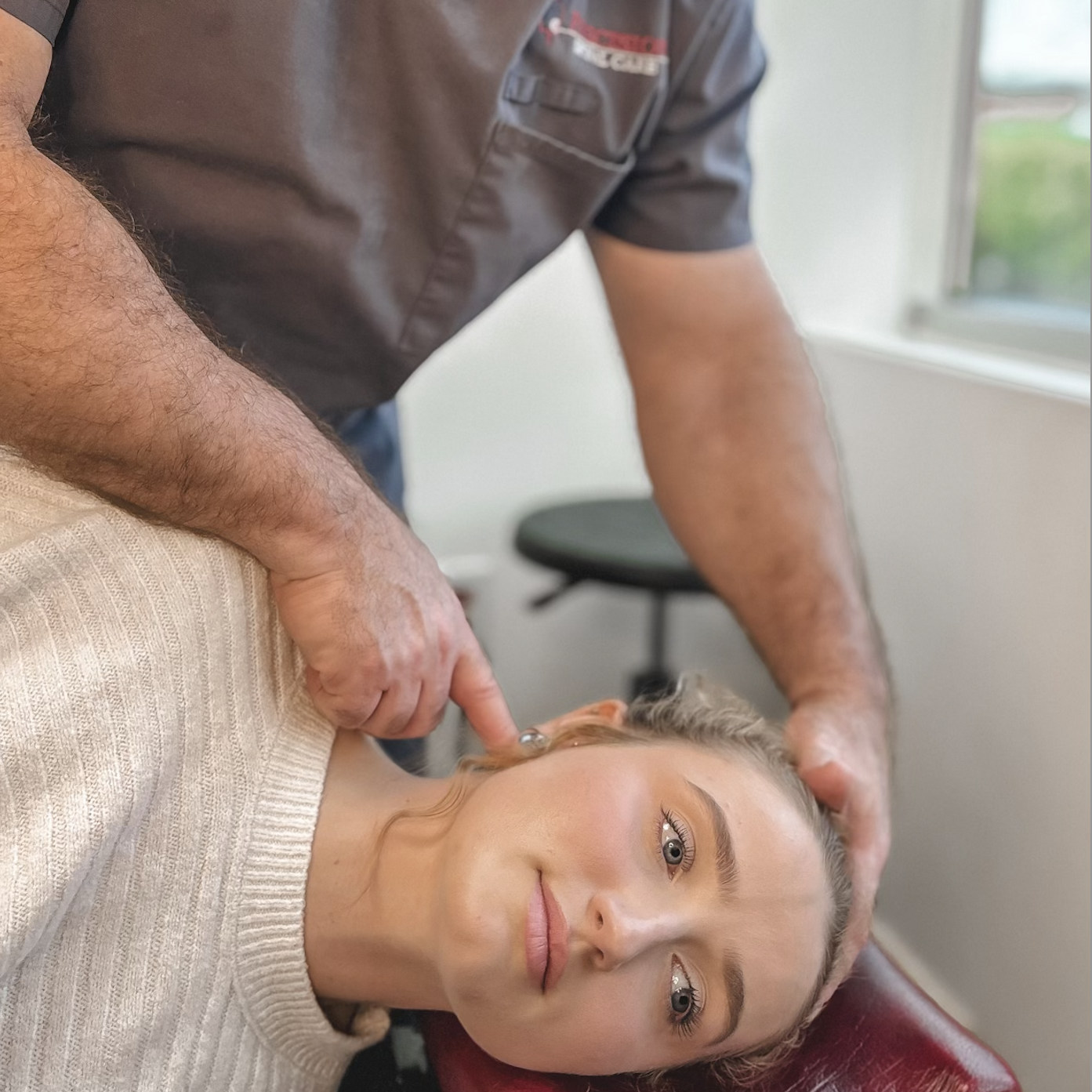 chiropractor performing NUCCA adjustment on patient