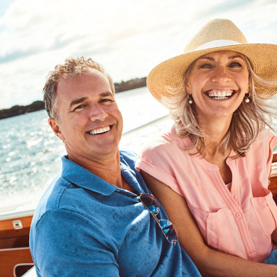 Smiling middle-aged couple enjoying a day on a boat