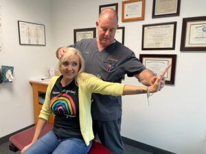 Dr. David Packer performing an orthopedic examination on a patient at Precision Spinal Care in Chesapeake VA